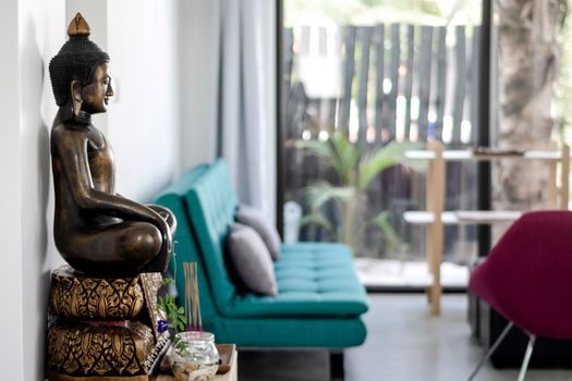 bronze buddha statue interior design detail in modern asian home living room