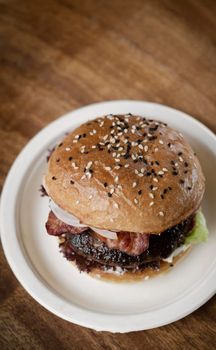 Australian organic beef burger with bacon on wood table