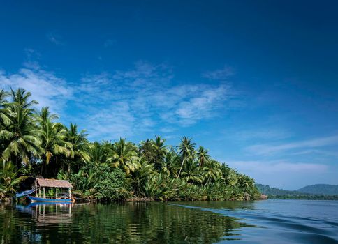 traditional boat and jungle hut on the tatai river in the cardamom mountains of cambodia