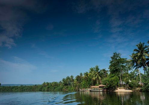 traditional jungle ferry boat at pier on tatai river in cambodia