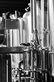 industrial beer brewing equipment detail in brewery interior in black and white