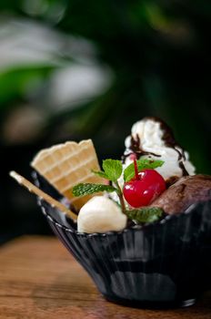 gourmet organic chocolate and strawberry ice cream sundae dessert with cherry and banana