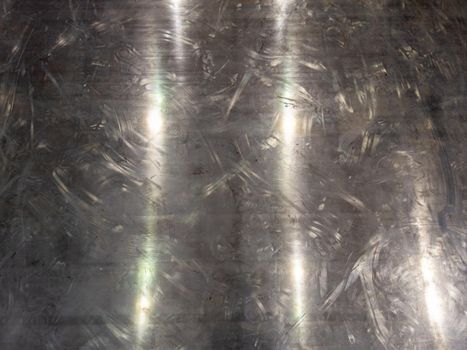 scratched shiny aluminium sheet metal floor full frame background.