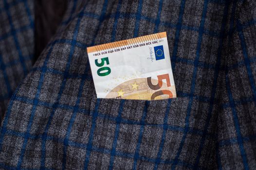 pocket of the plaid jacket coming out of 50 euro bills