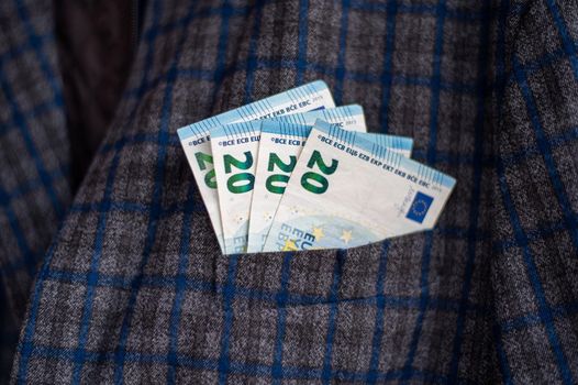 pocket of the plaid jacket coming out of 20 euro bills