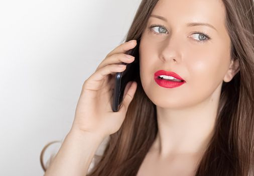 Happy smiling woman calling on smartphone, portrait on white background. People, technology and communication concept.