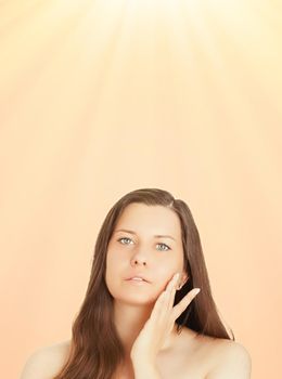 Sunny face portrait of young woman, suntan skin tone and beauty cosmetics. Beautiful brunette female model with natural tan using sunscreen product.