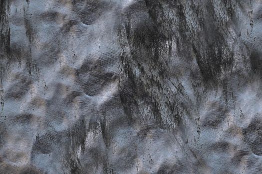 Textured uneven surface of the wall made of dark gray stone