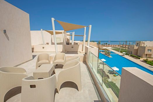 Roof terrace and furniture at a luxury apartment in tropical resort with sea view