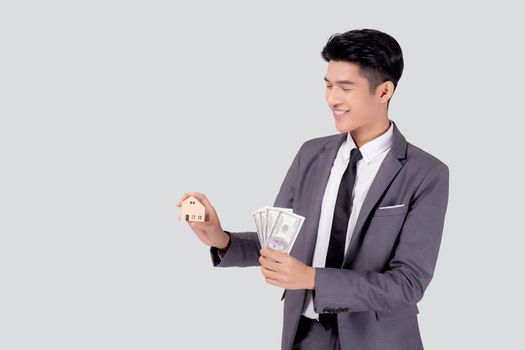 Young asian business man holding home and money dollar for saving for future, insurance agent and credit, debt and loan of finance, purchase home and refinance, investment about real property.