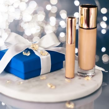 Cosmetic branding, Christmas glitter and girly blog concept - Holiday make-up foundation base, concealer and blue gift box, luxury cosmetics present and blank label products for beauty brand design