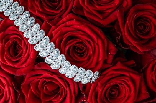 Gemstone jewellery, wedding fashion and luxe shopping concept - Luxury diamond bracelet and bouquet of red roses, jewelry love gift on Valentines Day and romantic holidays present