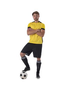 Soccer player standing with one foot on ball crossing arms isolated on white background