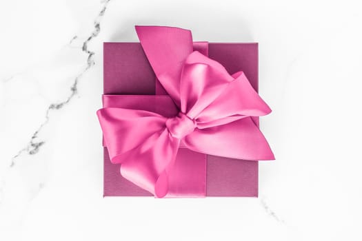 Birthday, wedding and girly branding concept - Pink gift box with silk bow on marble background, girl baby shower present and glamour fashion gift for luxury beauty brand, holiday flatlay art design