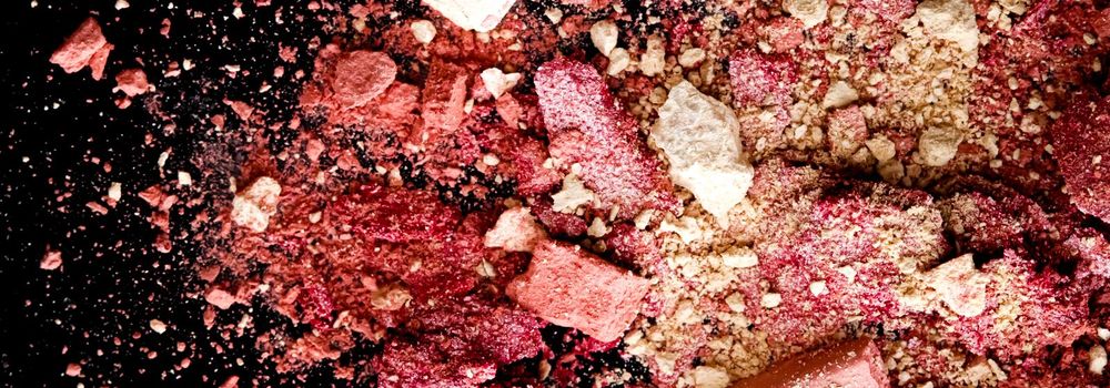 Crushed cosmetics, mineral organic eyeshadow, blush and cosmetic powder isolated on black background, makeup and beauty banner, flatlay design.