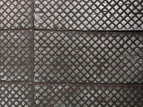 old cast iron factory floor tiles with checkered skid-proof flat pattern.