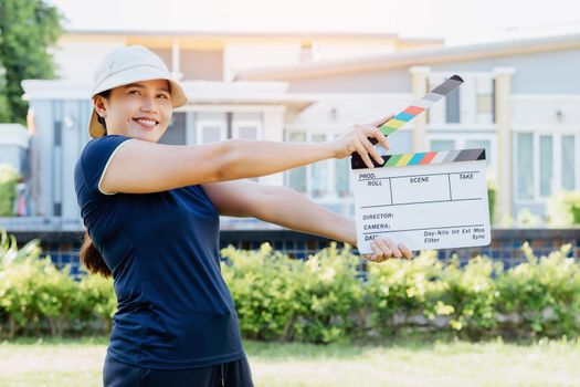 Asian woman holding film slate colors board for movie cinema and television industry