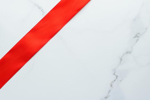 Holiday decor, feminine design and flatlay concept - Red silk ribbon on marble, top view