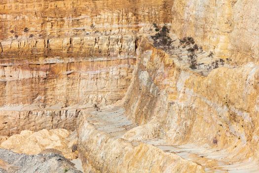 Photograph of crushed sand and stone laying on the ground in a large quarry