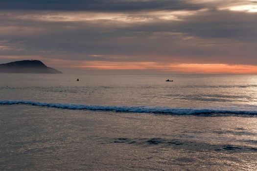 Photograph of small fishing boats in the Pacific Ocean at Terrigal Beach at sunset on the Central Coast in New South Wales in Australia