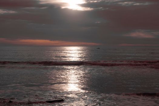 Photograph of small fishing boats in the Pacific Ocean at Terrigal Beach at sunset on the Central Coast in New South Wales in Australia