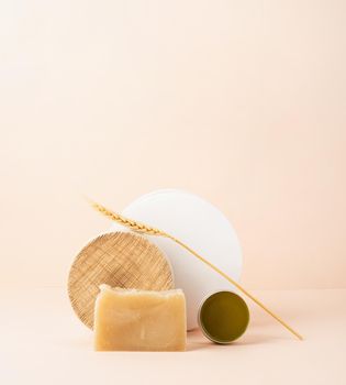 Natural cosmetics. Creative art composition with soap and balsam, natural cosmetics on beige background with copy space
