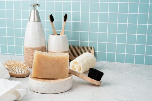 Bath accessories with bamboo brushes, handmade soap, dispenser and natural brushes on bath shelf, front view