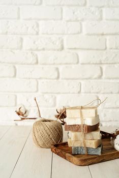 Natural organic cosmetics. Stack of hand made soap on white wooden background