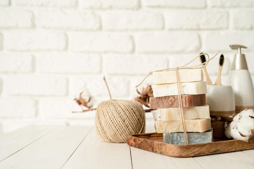 Natural organic cosmetics. Stack of hand made soap on white brick wall background