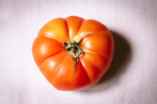 Uncooked raw red tomato. Raw food. No people