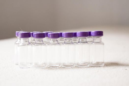 Empty glass jars of coronavirus vaccines. No people