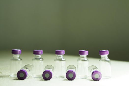 Empty glass jars of coronavirus vaccines. No people