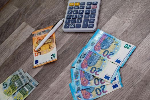 business in the office with euro banknotes and calculator on the table charts and objects