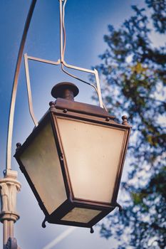 Old gas street lamp against the sky, vintage city lighting. Close up
