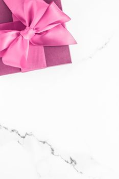 Birthday, wedding and girly branding concept - Pink gift box with silk bow on marble background, girl baby shower present and glamour fashion gift for luxury beauty brand, holiday flatlay art design