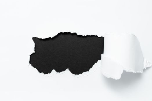 Tear on sheet reveals background behind the front side