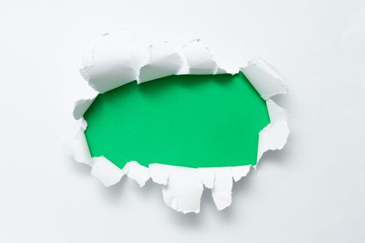 Tear on sheet reveals background behind the front side