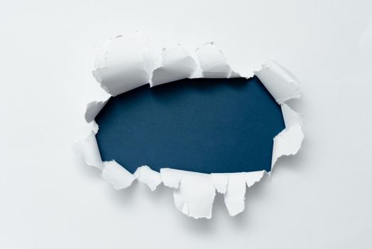 Tear on sheet reveals background behind the front side