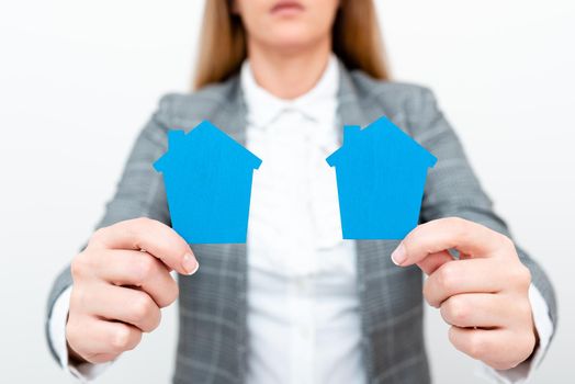 A Young Lady Businesswoman Holding Presenting Home In Business Outfit