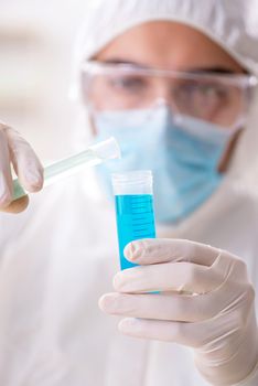 Young chemist student working in lab on chemicals