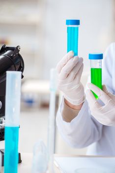 Woman chemist working in hospital clinic lab