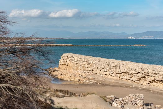 Grec Wall in Platja de Les Muscleres in La Escala behind the ruins of Empuries, in the Province of Giron, Catalonia, Spain.