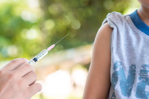 Close-up hand's doctor or nurses are vaccination to patient using the syringe injected upper arm for treated,Doctor giving an injection to a patient