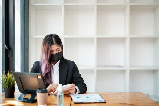 Business woman using a calculator to calculate working on desk in home office. Consultant,Financial Consultant,Financial advisor and accounting concept