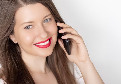 Happy smiling woman calling on smartphone, portrait on white background. People, technology and communication concept.