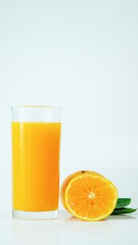 100% fresh-squeezed orange juice in a glass And citrus fruit split on white background. Concept of how to live with a naturally refreshing drink that contains vitamin C.