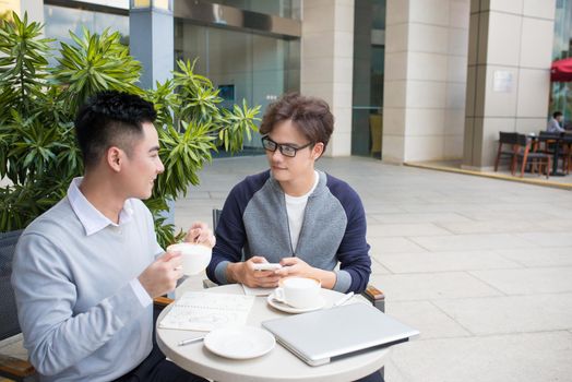 Two businessman having a casual meeting or discussion in the city.