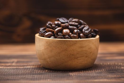 Coffee beans. Coffee cup full of coffee beans.
