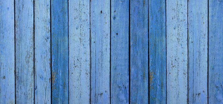 blue very old painted boards with peeling and cracked paint. Abstract vintage backdrop, banner