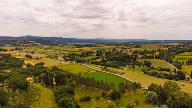 A stunning aerial view of the Tuscan countryside with its characteristic spring colors.